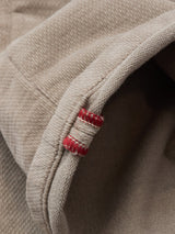 Close-up of the hem on Blue de Gênes BGpaulo Ottawa Trousers in Fungi, featuring detailed stitching and a red thread-reinforced seam—a signature quality of Italian-made chino pants.