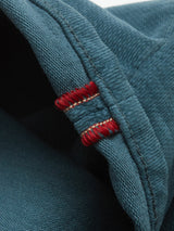 Close-up of Blue de Gênes BGpaulo Ottawa Trousers in Dark Slate, showing blue denim fabric with visible stitching and two parallel red and white seam details—signature craftsmanship expertly made in Italy.