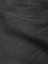 Close-up of the textured black-grey denim fabric on Blue de Gênes Giacomo BLK Used Jeans, highlighting the subtle diagonal weave and gentle creases characteristic of this relaxed, Italian-made style.