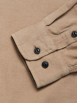 A close-up of the Zamboni Velu Shirt - Fungi by Blue de Gênes, showing its beige baby corduroy sleeve with visible textured ridges and a cuff secured by two black buttons.