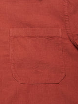Close-up of the Zamboni Velu Shirt in Henna by Blue de Gênes—a garment-dyed baby corduroy shirt with fine vertical ridges, a front patch pocket, and detailed stitching.