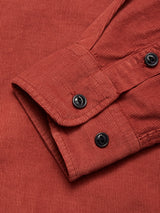 Close-up of the Zamboni Velu Shirt - Henna by Blue de Gênes, showing the red corduroy sleeve with two black cuff buttons and garment-dyed ribbed texture.