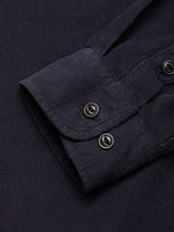 Close-up of the Blue de Gênes Zamboni Velu Shirt - Navy cuff, featuring two black buttons and showcasing its textured, ribbed baby corduroy fabric in a deep garment-dyed navy shade.