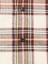 Close-up of the Blue de Gênes Robertino Brush Shirt - Stone, crafted from Sidogras cotton with a cream, brown, red, and yellow plaid design and two black buttons aligned vertically at the center.