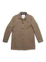 The Massone Check Coat by Blue de Gênes features a brown and black houndstooth pattern in Melton wool, with button closure, long sleeves, and two front pockets, shown laid flat on a white background.