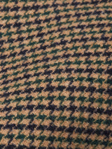 Close-up of the Massone Check Coat by Blue de Gênes, featuring luxurious Melton wool with a black, green, and tan check pattern—ideal for a stylish winter look.
