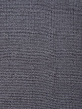 Close-up of Blue de Gênes’ Porto Knit in Dark Slate, featuring a textured fabric with a subtle grid-like woven pattern and small, raised rectangular shapes—perfect for menswear.