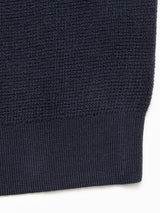 Close-up of the Porto Knit - Navy by Blue de Gênes, showcasing its textured wool fabric and ribbed hem against a white background.