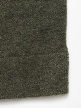 A close-up of Blue de Gênes Malakka Polo Knit - Army fabric, featuring its soft, fuzzy texture and slightly uneven edge, set against a white background.