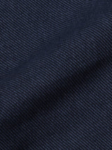 Close-up of a dark blue, textured fabric with a diagonal weave—perfect for cotton blend chinos or the refined Menzo Olanda Chino by Blue de Gênes, known for its signature tapered leg.