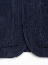Close-up of the bottom hem of the Blue de Gênes Masami Cord Blazer - Navy, highlighting its garment-dyed corduroy with textured vertical ridges and two rounded-edge pockets on each side.