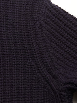 Close-up of the Yomaha Halfzip Knit in navy by Blue de Gênes, highlighting the chunky textured knit and wool blend fabric near the shoulder seam against a light background.