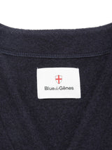 Close-up of the Koi Wool Gilet - Navy by Blue de Gênes, featuring a classic design with a dark blue boiled wool fabric and a white label under the brand's red and white shield logo.