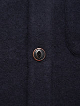 Close-up of the Blue de Gênes Koi Wool Gilet in navy, featuring a single round button sewn with black thread and showcasing the soft, textured wool fabric.