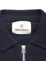 Close-up of the Nuvali Polo Cardigan in navy by Blue de Gênes, featuring a collar, silver zipper, and an inner label with the brand's name and shield logo. Ideal as a men's layering sweater.