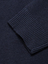 Close-up of the Nuvali Polo Cardigan - Navy by Blue de Gênes, highlighting the ribbed wool blend sleeve with its detailed knit texture and cuff.