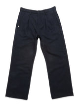 The Blue de Gênes Kibishi Solid Pant in dark navy is a straight-leg style crafted from an Italian wool blend with pleats, belt loops, and a button closure, shown laid flat on a white background.