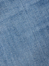 Close-up view of the light blue comfort stretch denim fabric of Blue de Gênes Vinci Girisha Used Jeans, highlighting the diagonal weave pattern and texture typical of regular fit jeans.
