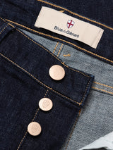Close-up of Vinci Girisha Rinse Jeans by Blue de Gênes: blue regular fit with three shield-engraved metal buttons, a Blue de Gênes fabric label and logo, visible five-pocket style, and lighter inner denim.