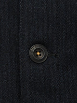 Close-up of the Vincenzo Solid Jacket - Dark Navy by Blue de Gênes, featuring a black engraved button. This relaxed fit coat is expertly crafted from a premium Italian wool blend.