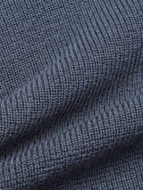 Close-up of the Porto Polo Knit - Dark Slate by Blue de Gênes, showcasing its textured ribbed fabric with vertical lines and soft folds that emphasize the luxury knitwear quality.