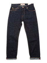 A pair of Blue de Gênes Marco Rinse Jeans in rinse wash, featuring 100% cotton dark blue denim, rolled cuffs, gold stitching, and front and back pockets, displayed flat against a white background.