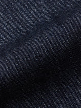 Close-up of Blue de Gênes Marco Rinse Jeans dark blue 100% cotton denim with visible diagonal weave and fine white specks, highlighting texture and slight fold—ideal for relaxed fit or used styles.