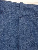 Close-up of the waistband and upper section of blue denim jeans, highlighting a belt loop and stitching details, resembling the durable finish seen on Blue de GĂȘnes' Shogun Fano Pant - Denim Blue.