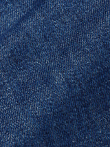 Close-up of the Shogun Fano Pant - Denim Blue by Blue de GĂȘnes, highlighting its heavy cotton blend denim fabric with a diagonal weave and rich variations in blue tones.