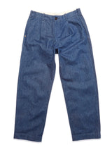The Blue de GĂȘnes Shogun Fano Pant in Denim Blue features a button and zipper closure, waist pleats, side pockets, and a relaxed straight-leg fit in heavy cotton blend, shown laid flat on a white background.