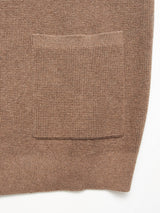 Close-up of the Gifu Knit Cardigan - Chocolate by Blue de Gênes, featuring a brown wool blend, large rectangular pocket, ribbed texture, and simple lines—an elegant classic from the Gifu Knit Cardigan collection.