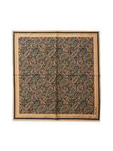 The Siruku Scarf - Mixed Colours by Blue de Gênes is a square cotton scarf with a detailed paisley and floral pattern in dark green, tan, and black, framed by tan and black borders. It’s displayed neatly with slight creasing.