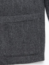 Close-up of the Fukui Blazer - Black Pattern by Blue de Gênes, showing a large rectangular front pocket and edge stitching—a refined take on relaxed tailoring.