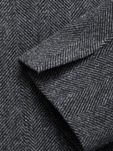 Close-up of the Fukui Blazer - Black Pattern by Blue de Gênes, highlighting grey herringbone fabric with overlapping sections and fine diagonal lines—a mark of contemporary tailoring.