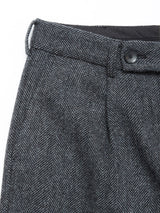 Close-up of the waistband and upper section of Blue de Gênes Kyoto Pant - Black Pattern trousers, featuring a belt loop, pleats, and a black button at the top.