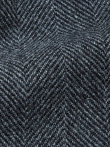 Close-up of dark gray herringbone fabric, showcasing the textured zigzag weave and soft wool fibers featured in Blue de Gênes Kyoto Pant - Black Pattern.