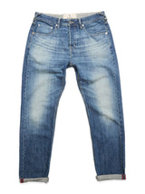 The BGgiacomo Tim Jeans - Antique wash by Blue de Gênes are relaxed fit blue rigid denim jeans with a faded, worn look, five pockets, visible stitching, and rolled-up cuffs, shown laid flat on a white background.