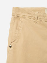 Close-up of Blue de Gênes BGmenzo Vecchio Chino in Pale Khaki shows front pocket with a black and white stitched logo, visible belt loops, comfort stretch fabric, and detailed stitching.