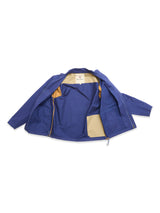 The BGcanopy Jacket - Navy Peony by Blue de Gênes is laid flat with its front open, showing a beige lining and right-side inner pocket. This heavy cotton utility jacket has long sleeves and a zipper closure, reflecting its workwear roots.