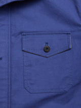 Close-up of the BGcanopy Jacket - Navy Peony by Blue de Gênes, showing a buttoned flap pocket with visible stitching and part of the front placket—details that highlight its classic workwear-inspired style.
