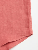 Close-up of the BGenric Hope L/S Shirt - Coral by Blue de Gênes, highlighting the pink linen fabric's breathable weave and stitching detail at the edge, displayed on a white background.