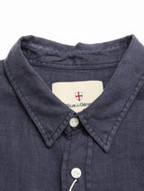 Close-up of the Blue de Gênes BGenric Hope L/S Shirt in dark navy linen, featuring a cut away collar, white buttons, and a beige inner label with the brand’s red and white shield—an ideal breathable summer shirt.