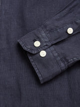 A close-up of the Blue de Gênes BGenric Hope L/S Shirt in Dark Navy highlights the cuff and sleeve with two white buttons and fine stitching on textured, breathable linen—ideal for summer wear.