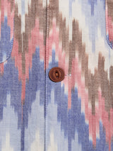 Close-up of the BGponti Kala S/S Shirt by Blue de Gênes shows its multi-pattern zigzag fabric in blue, pink, brown, and white, with a central brown button and pocket seam—ideal for unique 100% cotton shirt style.