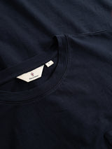 Two dark navy crewneck BGoscar T-Shirts by Blue de Gênes are shown, one folded neatly atop the other. The visible shirt’s tag features the brand logo. Made from 100% cotton.