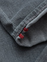 Close-up of the hem on Blue de Gênes Repi Giulio Light V2 Jeans in grey denim, featuring detailed stitching, a subtle red inner seam thread, and visible texture in the comfort stretch fabric.