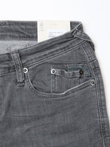 Close-up of the upper front section of Blue de Gênes Repi Giulio Light V2 Jeans in grey denim, highlighting the slim-fit waistband, front and coin pockets, belt loop, and a clothing tag inside the comfort stretch denim.