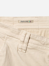 Close-up of Blue de Gênes BGpaulo Pavia 1 V2 Chino in Ecru, showing belt loops, a pocket, and a "Made in Italy" fabric label with an Italian flag; crafted from premium cotton stretch fabric.