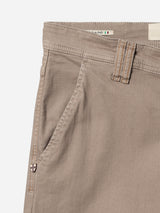 Close-up of the BGpaulo Pavia 1 V2 Chino - Fungi by Blue de Gênes, showing the pocket, waistband with visible stitching, belt loop, cotton stretch fabric, shield-shaped logo near the pocket, and a Made in Italy tag inside.