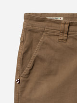 Close-up of Blue de Gênes BGpaulo Pavia 1 V2 Chino - Fudge showing waistband, front pocket, belt loop, Made in Italy label with Italian flag, and stitched emblem near the pocket on these cotton stretch chinos.